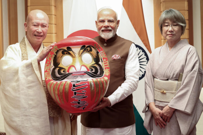 PM Modi Japan Visit Daruma doll presented to PM Modi